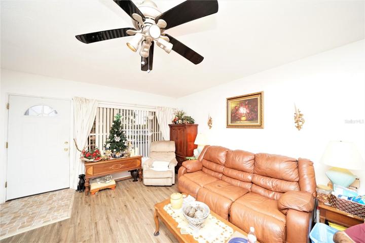 LIVING ROOM with ceiling fan, WATER-RESISTANT ViNyL FLOORING, and more