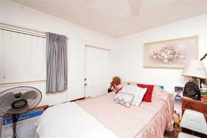 Second Bedroom that conveniently fetures Exterior Door, Ceiling Fan, and Water-Resistant Vinyl Flooring.