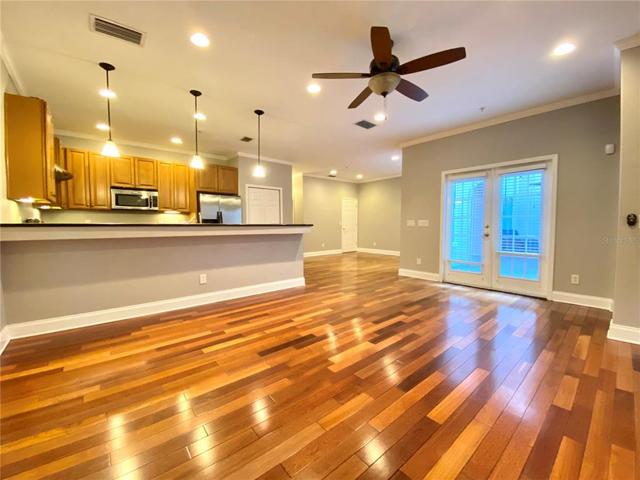 Living room open to kitchen. French doors open to courtyard