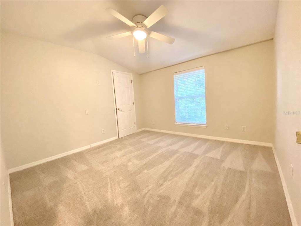 Second bedroom with walk in closet and new carpets
