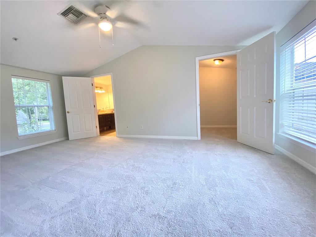 Master Bedroom with new carpets, large walk in closet, and on-suite bathroom