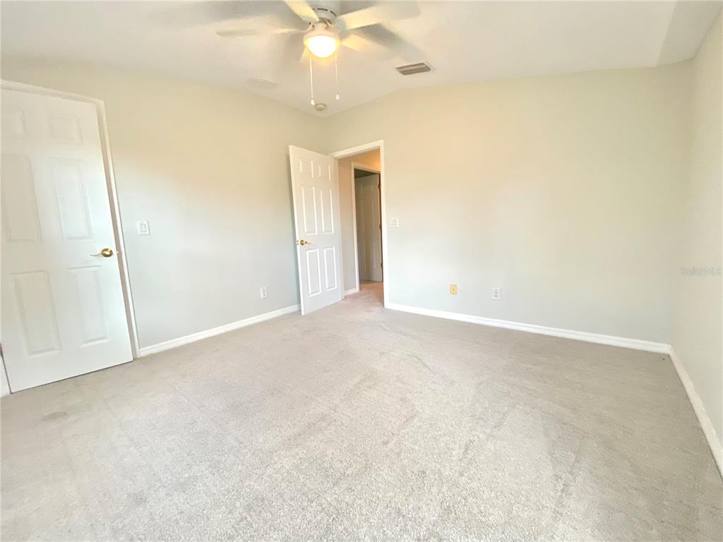 Third bedroom with walk in closet and new carpets