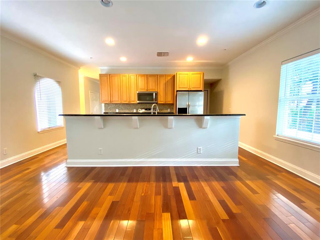 Kitchen and dining combo, with stainless steel appliances, and large island