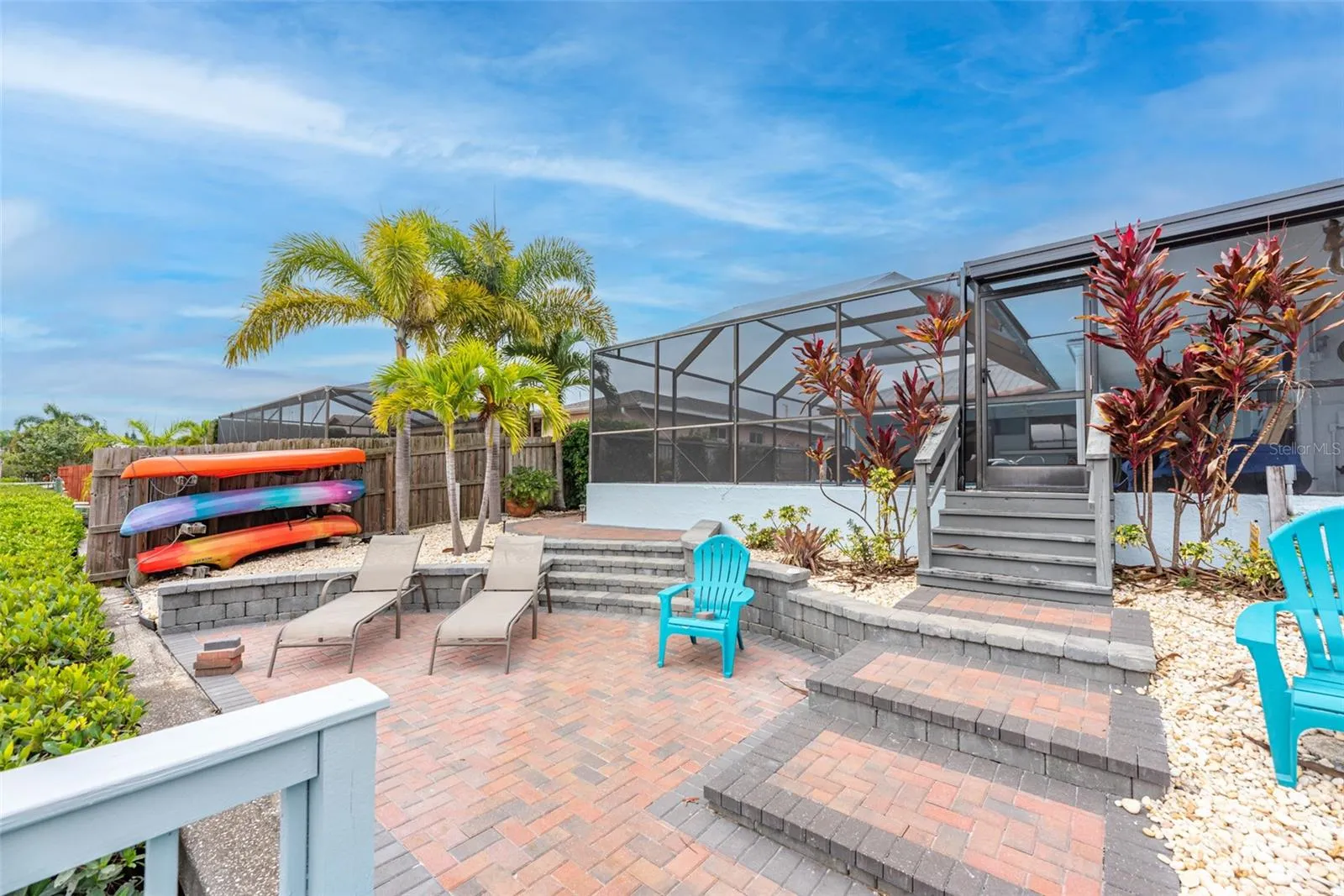 Stairs from the screened pool area lead down to the dock area.