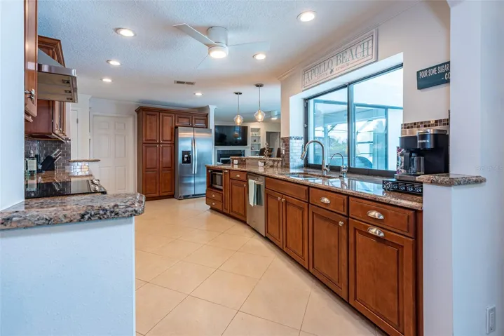 Notice the window behind the sink, it is a pass thru window in case you want to pass food through to those out in the screened lanai for bug free dining.