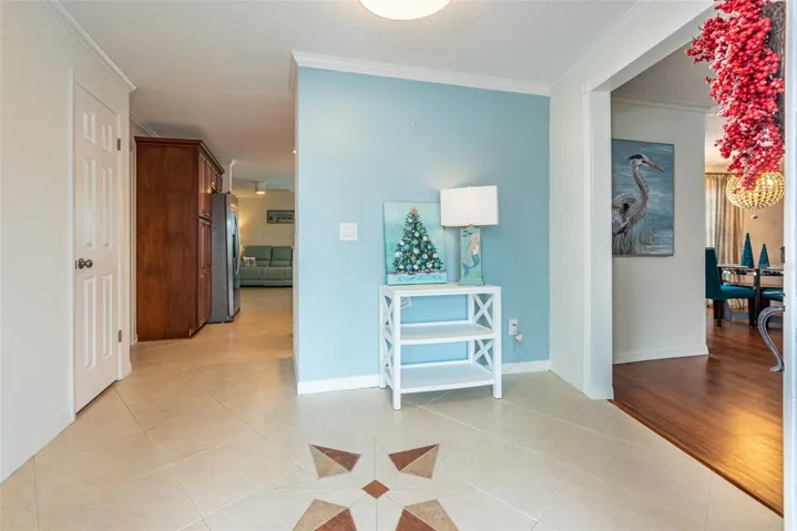Entryway.  To the right is the formal living/dining area.  Straight ahead is the family room with the kitchen behind the half wall.