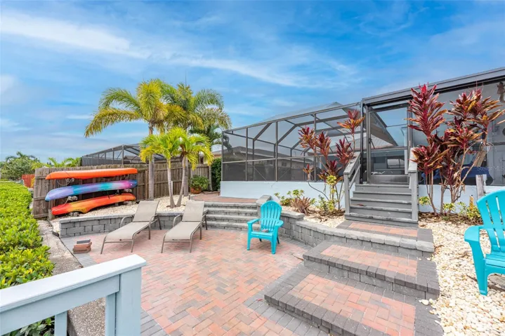 Stairs from the screened pool area lead down to the dock area.