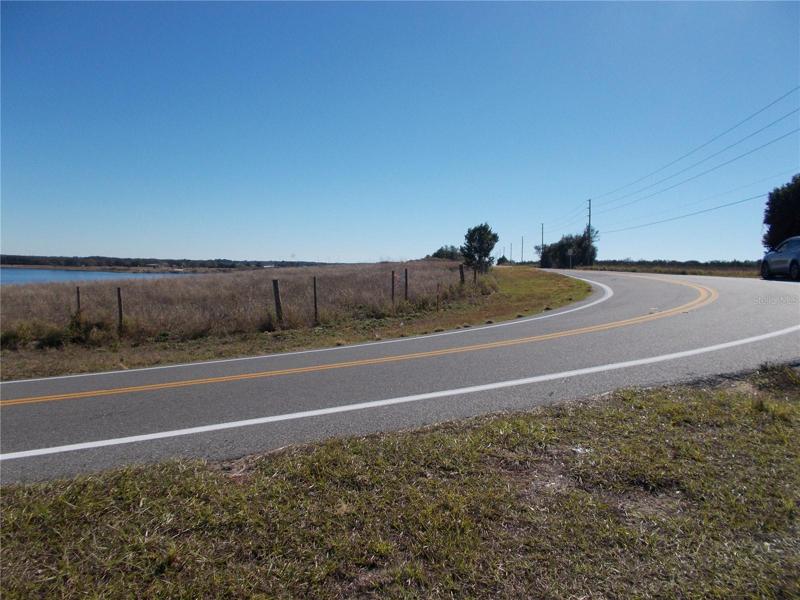 Sharp curve yellow arrow across from the easement dirt road look to the right