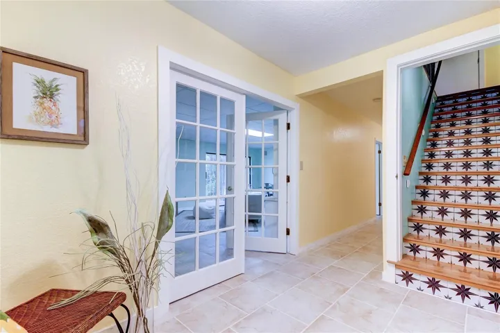View Into Foyer From Front Door. Stairs Lead to Second Floor. Hallway Leads to ELEVATOR and Living Area. Doors Lead to Family Room/Game Room
