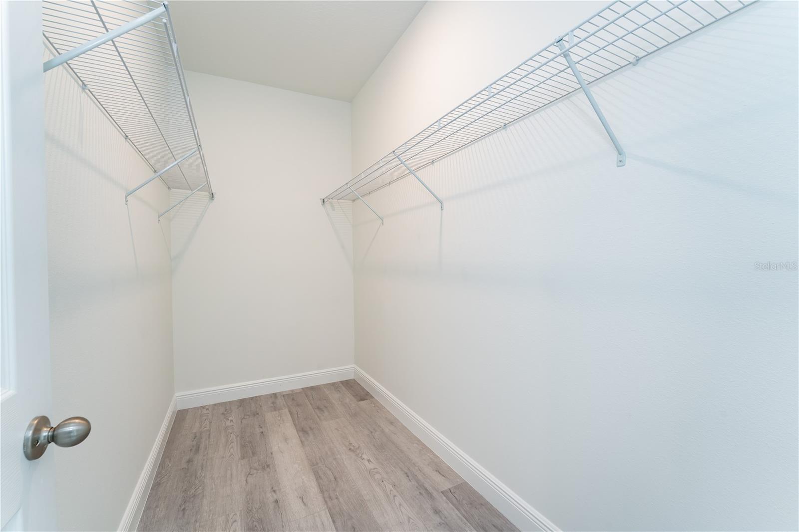 Large walk-in closet in the primary bedroom. This is a model; the actual colors, finishes, and orientation may be different.
