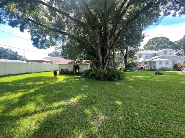 The home sits on the land right of the tree. The left side of the tree is the separate vacant land parcel