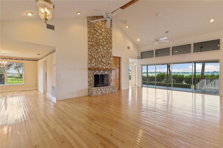 Great room with wood burning fireplace and river views