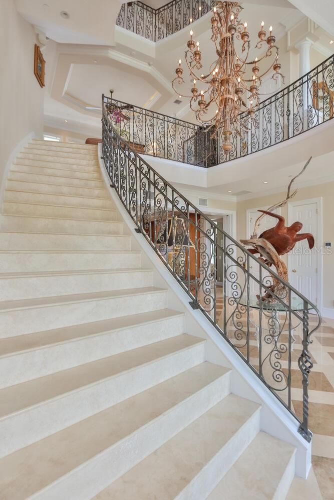 Stairway to the second level, chandelier on a pulley for easy cleaning
