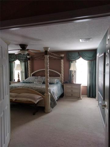 Entering into the large master bedroom from the second floor family room/loft area