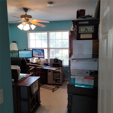The fourth bedroom, right next to the master bedroom, is being used as an office. It has a large closet and a beautiful double window view of the front of the house