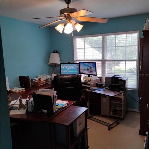 The fourth bedroom, right next to the master bedroom, is being used as an office. It has a large closet and a beautiful double window view of the front of the house