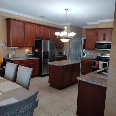 The large kitchen with stainless steel appliances, granite countertops and 42" cherry cabinets