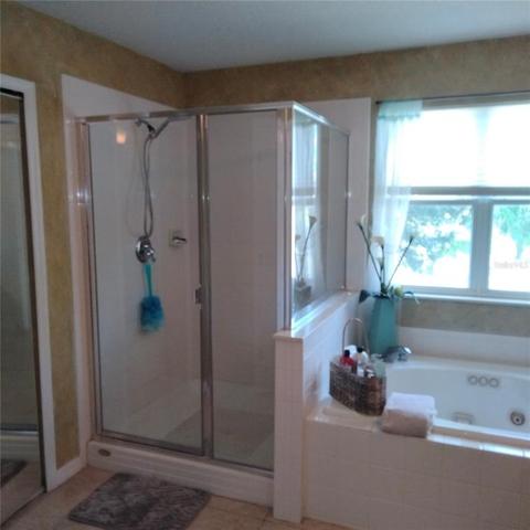The Master bedroom has a jetted roman tub and large shower stall with a beautiful view of the pond
