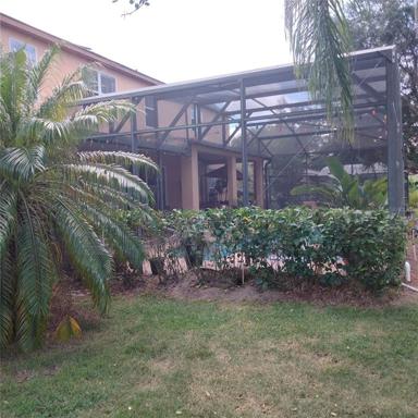 Right Side view of screened-in pool and spa