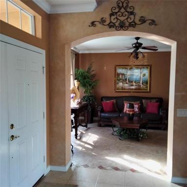 view from the formal dining room looking towards the Formal Living room with the main entrance to the home on the left