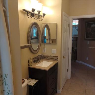 First floor pool bathroom with a large shower, next to the first floor bedroom