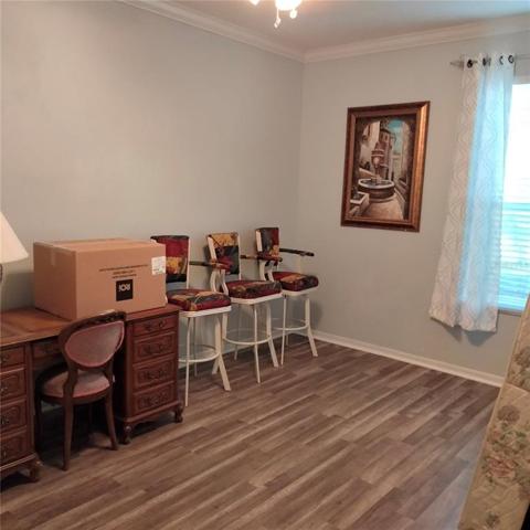 First Floor bedroom with laminate flooring and large window with view of the pond in the back of the house