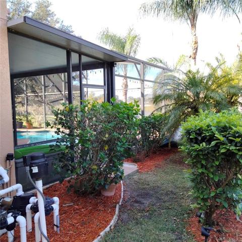 Pool equipment and right side view of the screened-in pool and spa