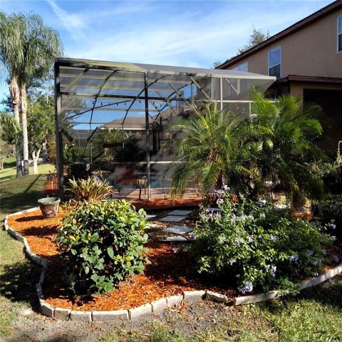 Side view of screened-in pool and spa