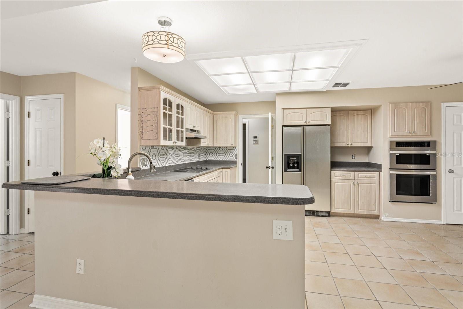 Kitchen overlooks Family Room and views of secondary bedrooms hallway