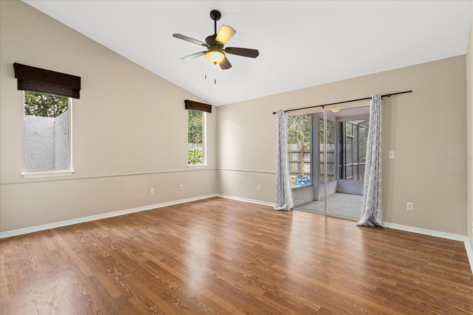 Master bedroom with en-suite and sliding door access to screened porch and lanai