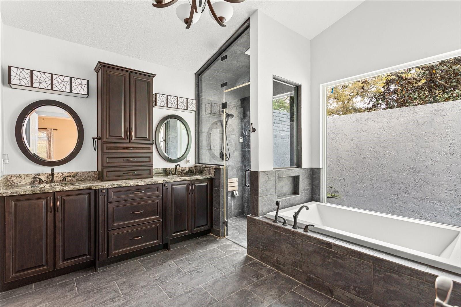 Master bathroom with oversized soaker tub, stall shower and large walk-in closet