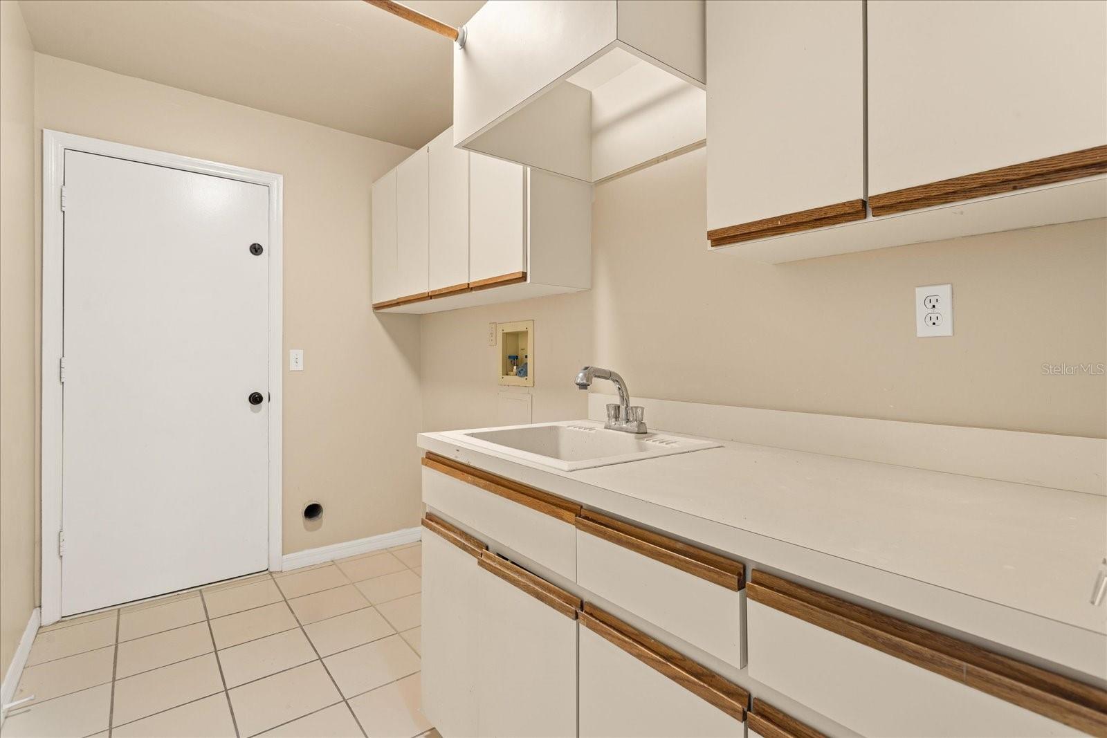 Laundry Room with folding table, utility sink and extra cabinets