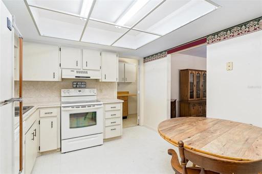 Eating space in the kitchen for a dinette , connects to dining room and laundry access.