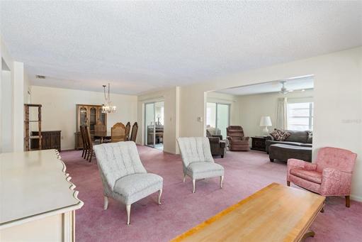 Living room with a view of the dining, family room & Florida room