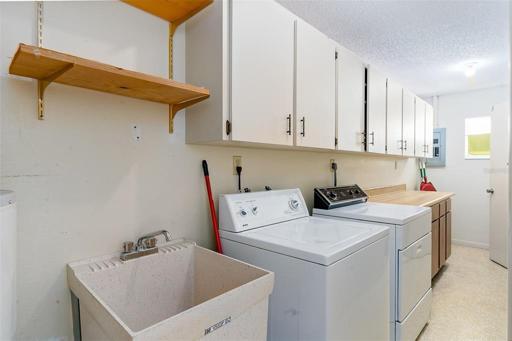 Spacious laundry room with a tub sink, storage galore & washer / dryer included!