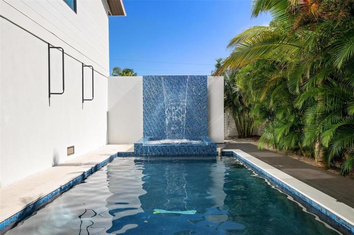 Heated pool and spa with waterfall feature