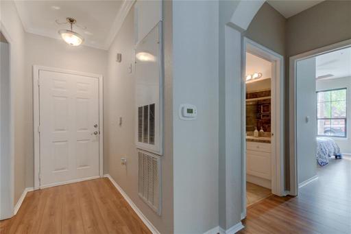 View of Front Door from inside, 2nd bathroom and 2nd bedroom to the right