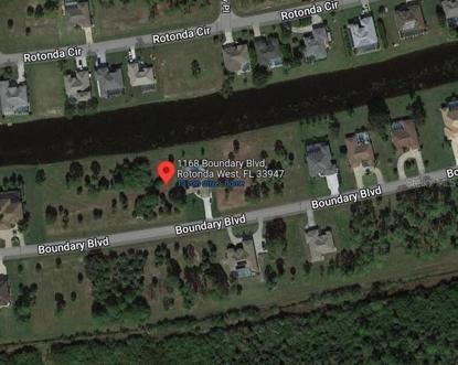Sparsely wooded, water frontage.