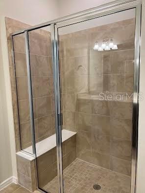 Master bathroom with walk in shower with seat