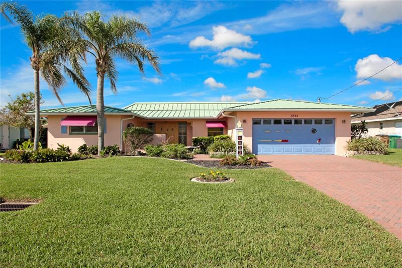 Lush landscaping and nautical artistic touches greet you as you arrive at this coastal inspired home!