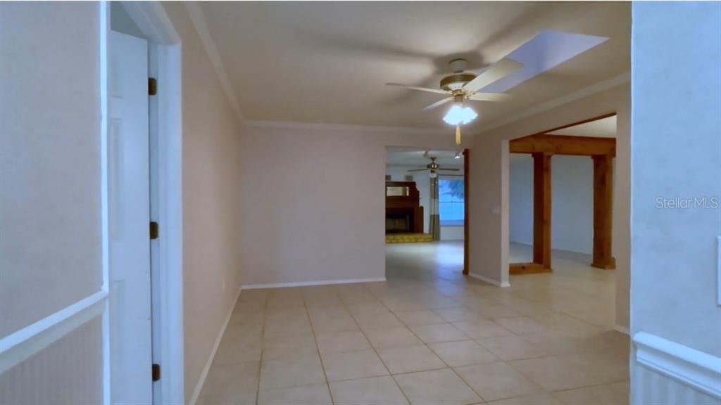 The living room features a skylight which offers plenty of natural light.