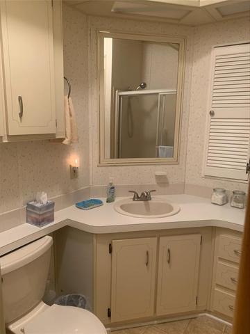 Bathroom #1 corner vanity with lots of storage.