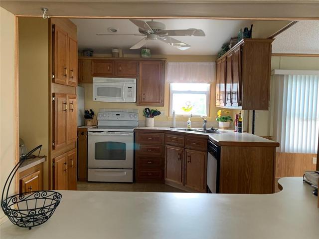 Kitchen with wooden cabinets all appliances included. View from Livingroom pass through.