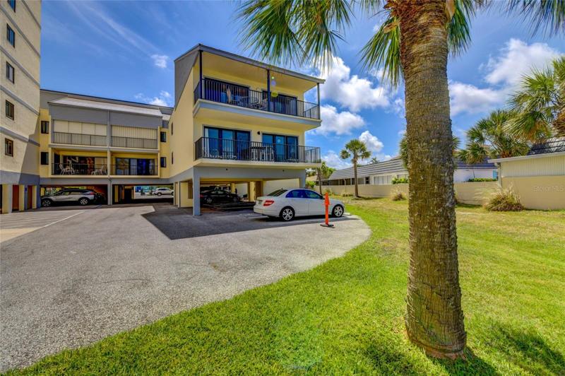 Exterior View Of Condo From Lawn And Pool Area!