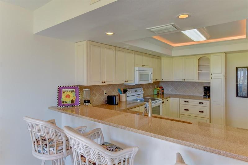 View Of Large Kitchen With Breakfast Bar Seating!
