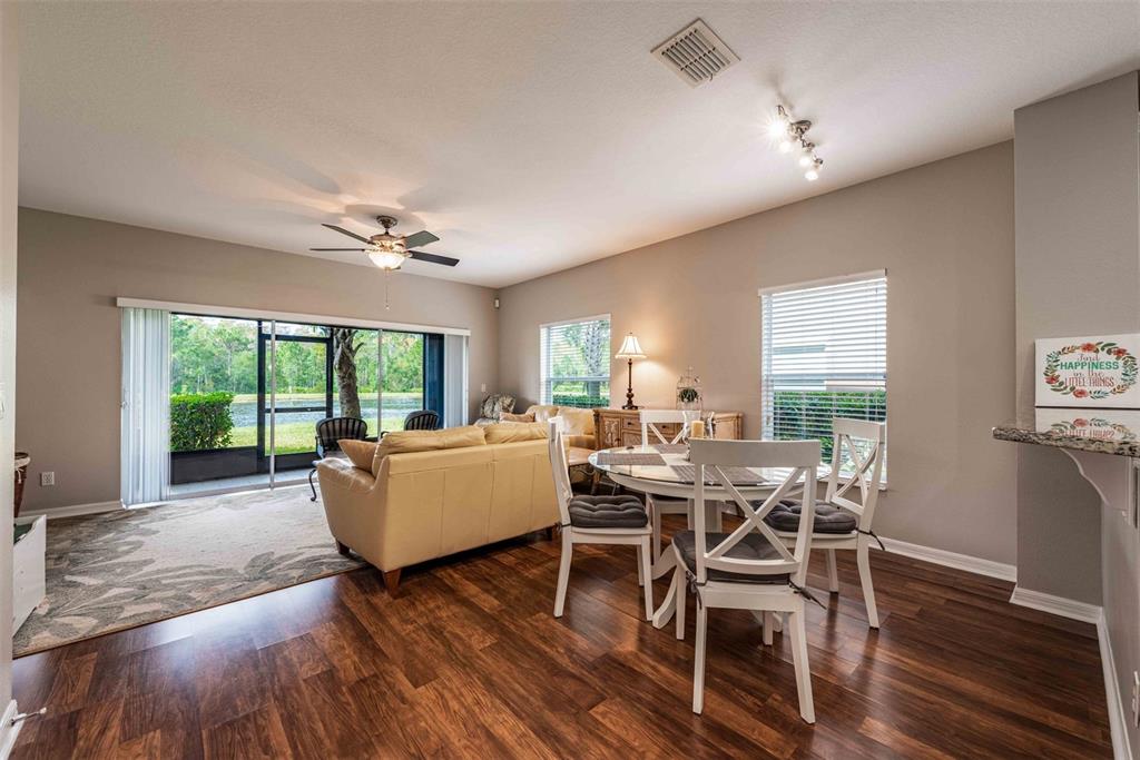 The living and dining room combo provides an open feel with HIGH CEILINGS and SLIDING GLASS DOORS that give refreshing NATURAL LIGHT as well as lanai access.