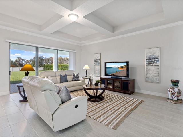 Living room with sliding glass doors that lead to backyard.