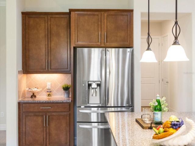 Additional cabinet space with LG fridge.