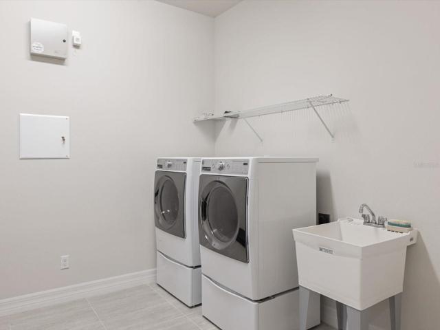 Laundry room with large washer and dryer.