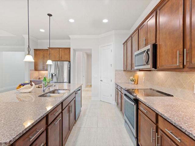 Kitchen with wood cabinets and granite countertops.